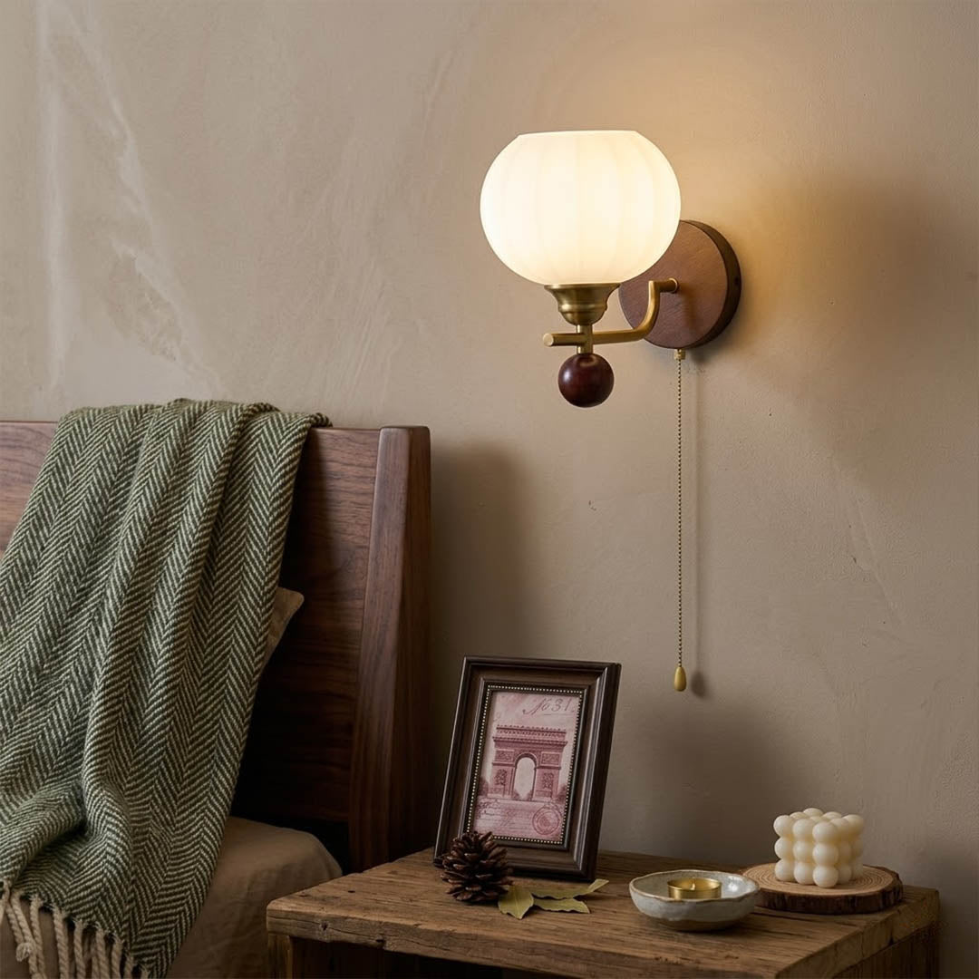 Crescent wall lamp pair beside bed bedroom warm frosted glass glow wood interior