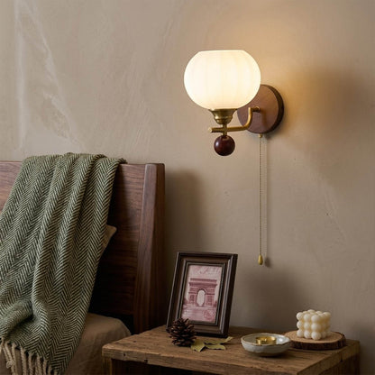 Crescent wall lamp pair beside bed bedroom warm frosted glass glow wood interior
