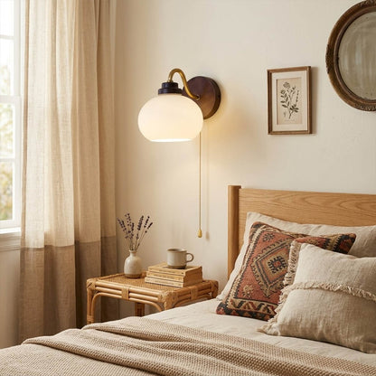 Crescent wall lamp pair beside bed bedroom warm frosted glass glow wood interior
