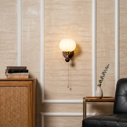 Crescent wall lamp pair beside bed bedroom warm frosted glass glow wood interior