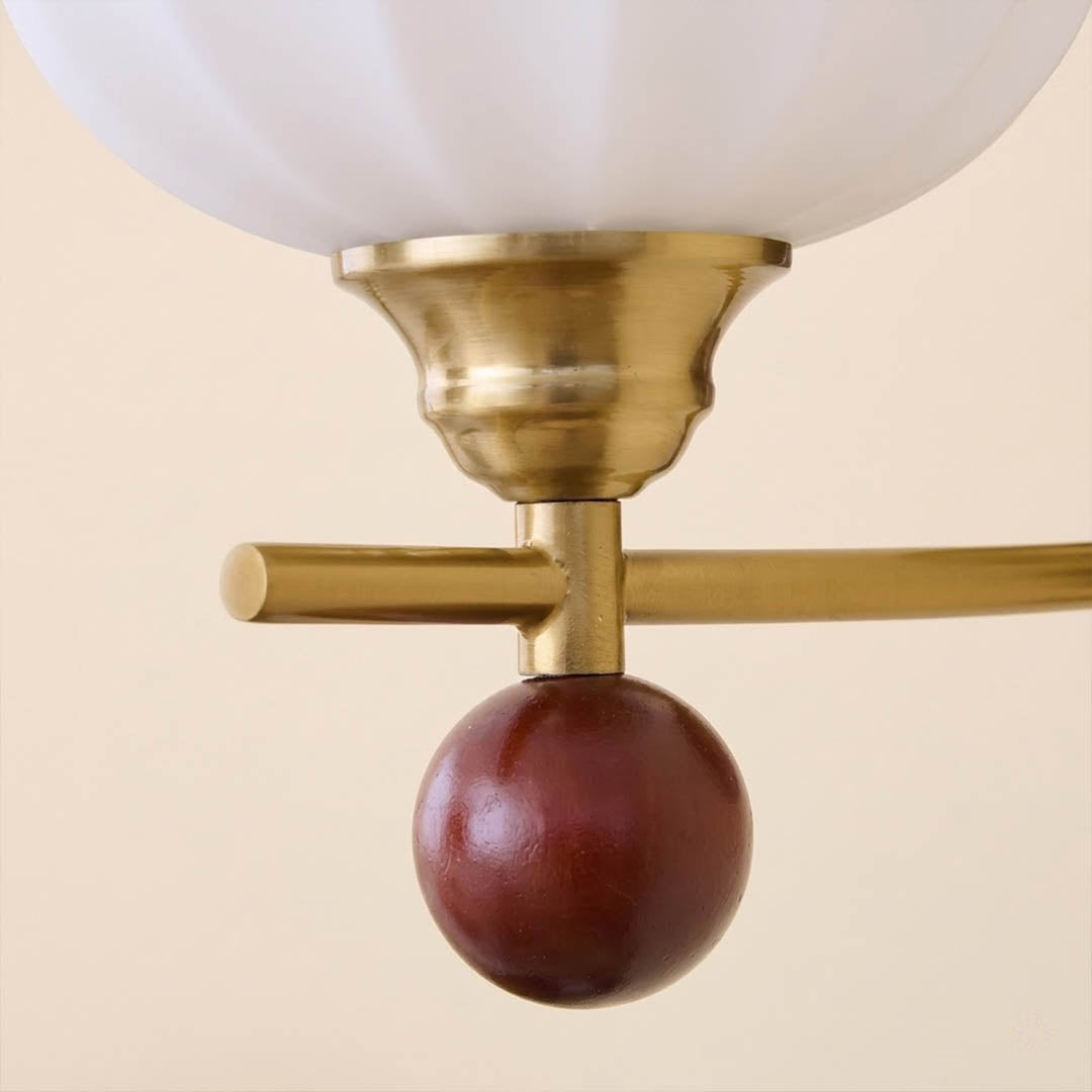 Crescent wall lamp curved metal arm wood base frosted glass globe detail close up