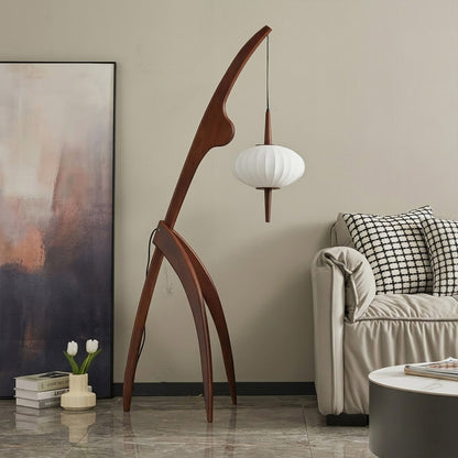 Cygnus walnut wood floor lamp behind sofa living room long arm reaching over seating warm silk glow transitional interior