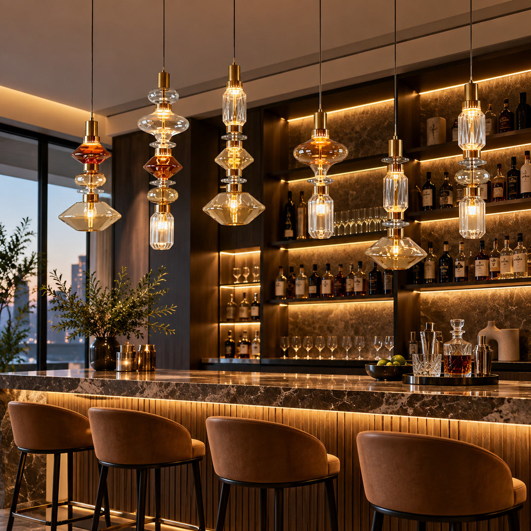 Danza glass pendant lights over a cocktail bar counter