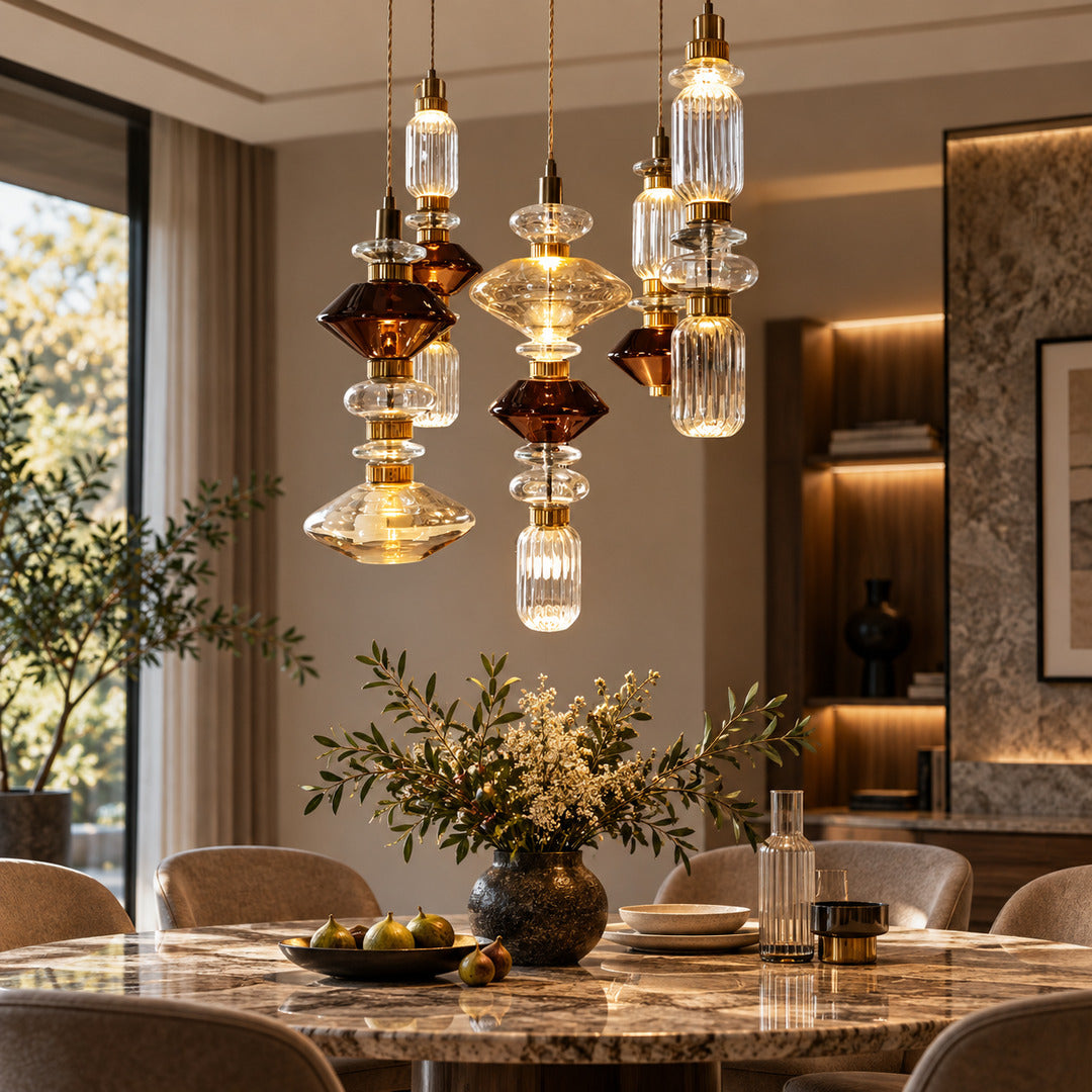 Danza glass pendant lights at staggered heights over a dining table