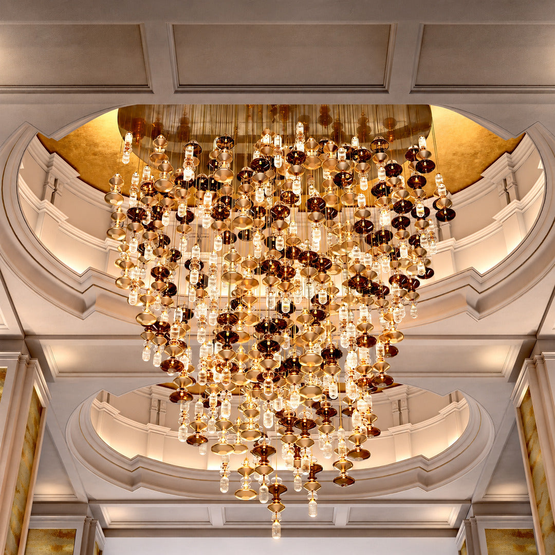 Six-head Danza glass pendant cluster as a focal point in a hotel lobby