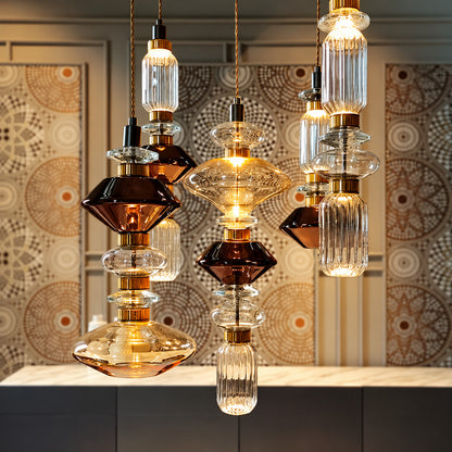 Danza glass pendant lights at staggered heights over a dining table