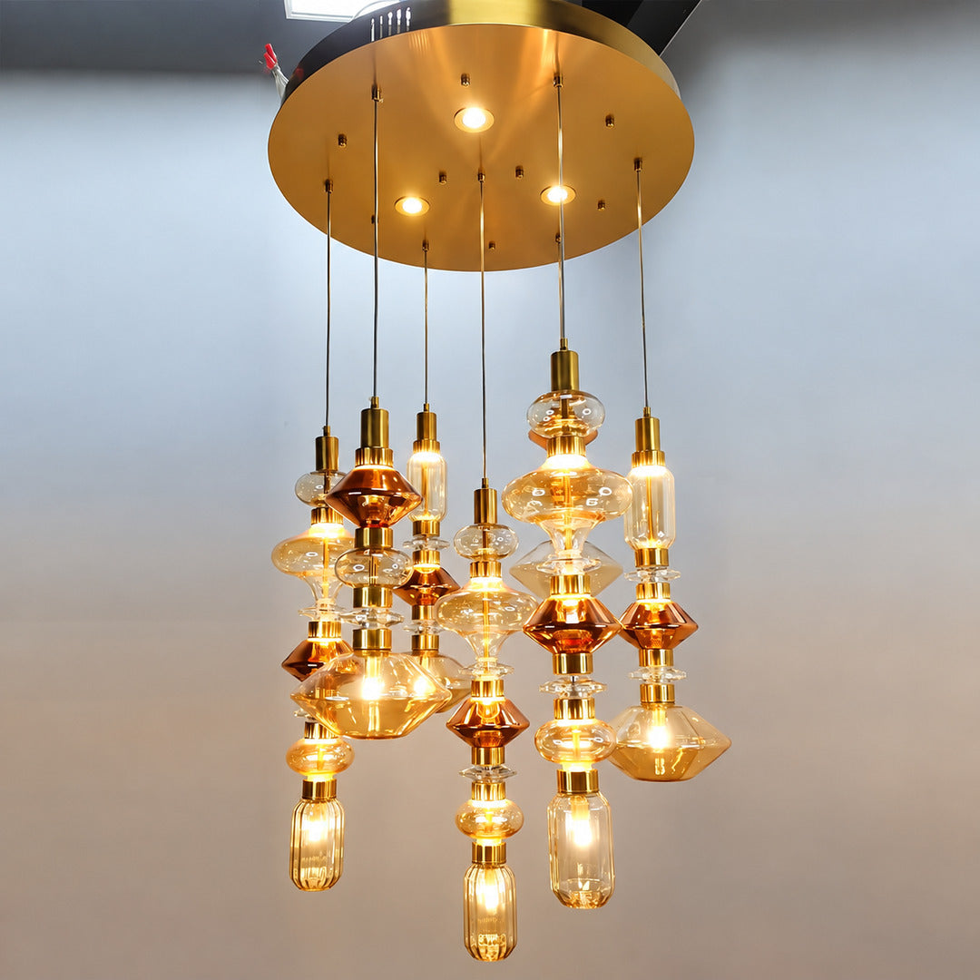 Six-head Danza glass pendant cluster on a round canopy in a double-height foyer