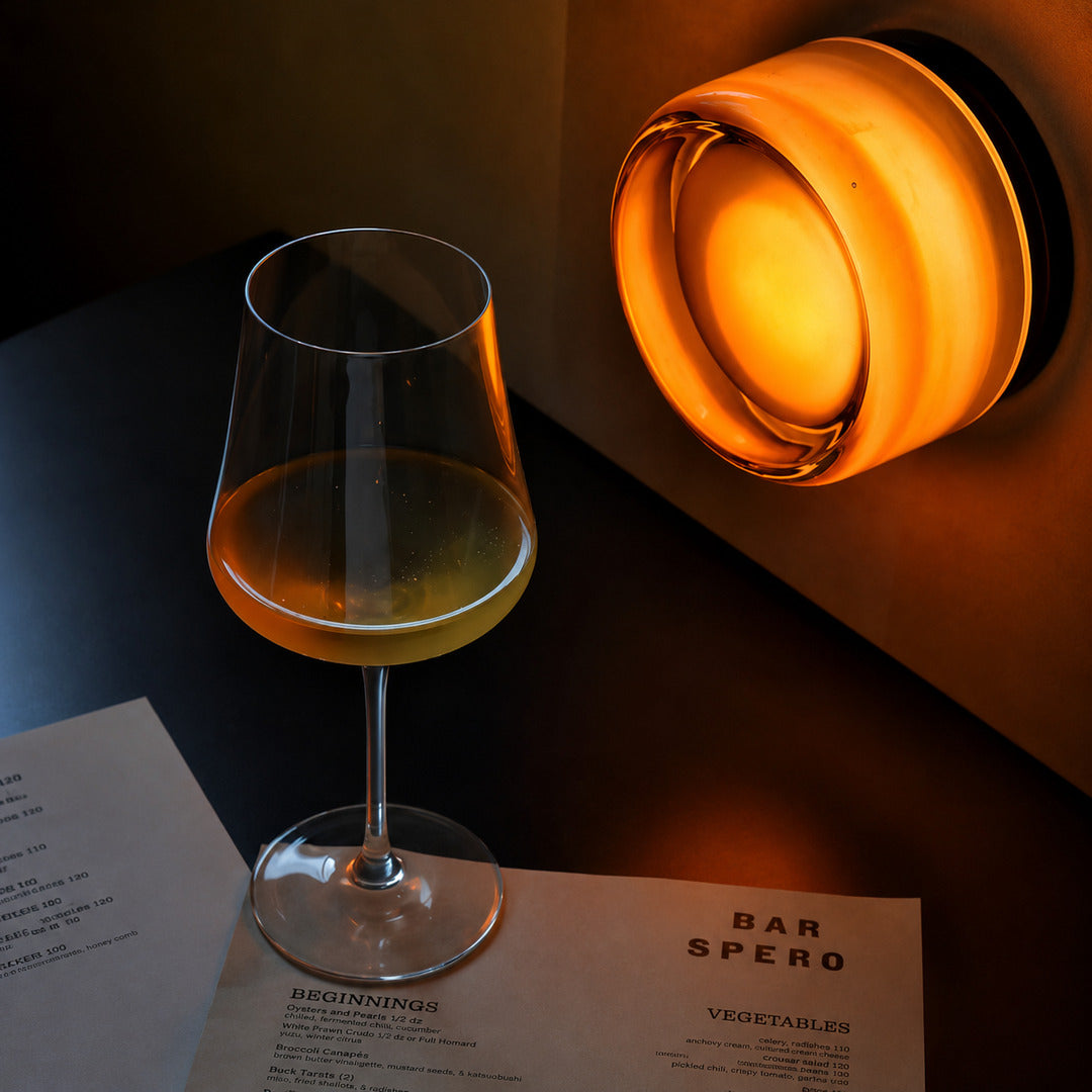 Warm evening glow of the amber Demi glass wall sconce creating a cozy ambiance after dark