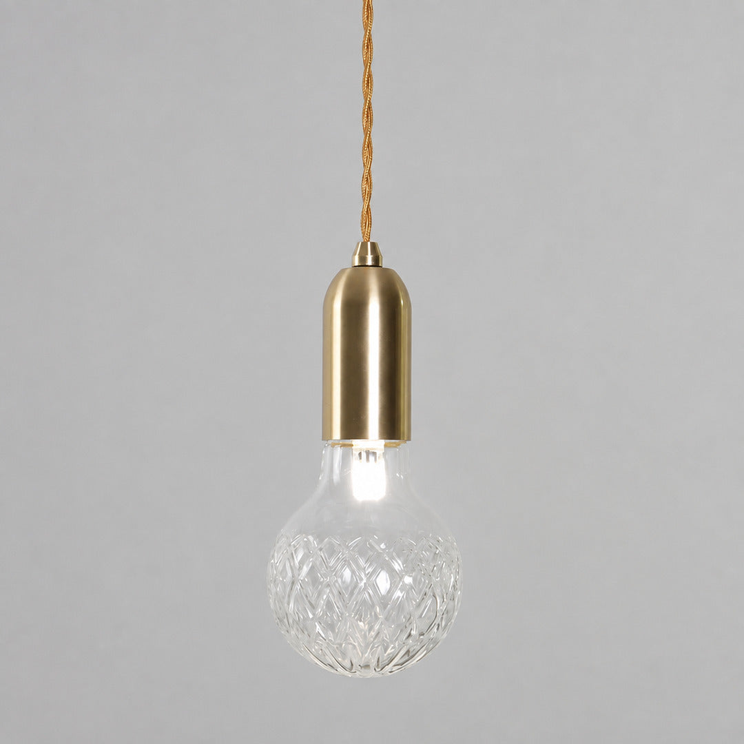 Single Diamante cut-glass pendant light hanging over a kitchen counter or bedside table