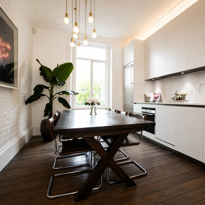 Row of Diamante cut-glass pendant lights suspended over a modern kitchen island