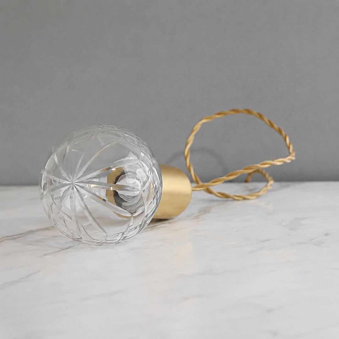 Close-up of the faceted diamond-cut glass bulb shade on the Diamante pendant light catching the light