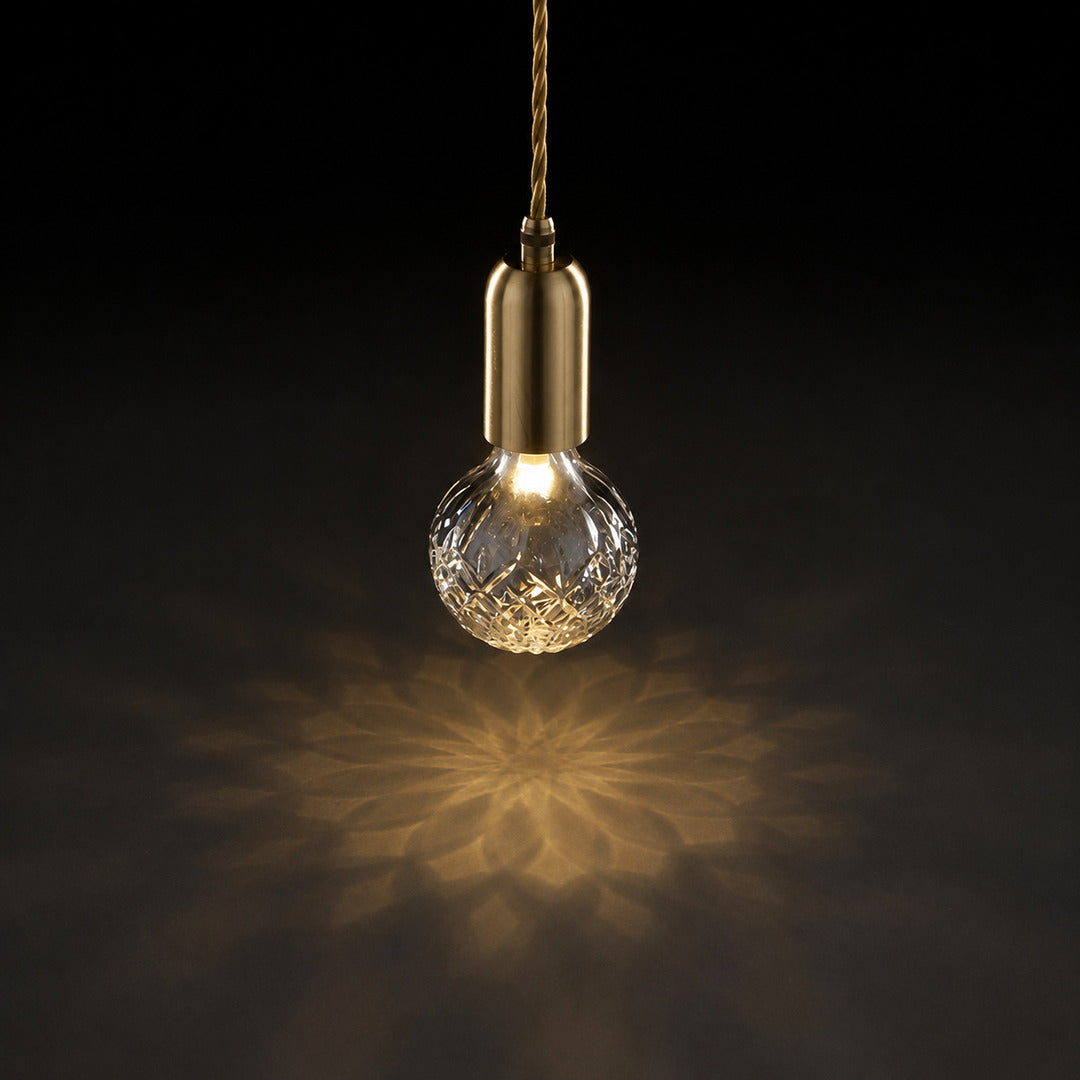 Warm light sparkling through the faceted cut-glass shade of the Diamante pendant like fine crystal