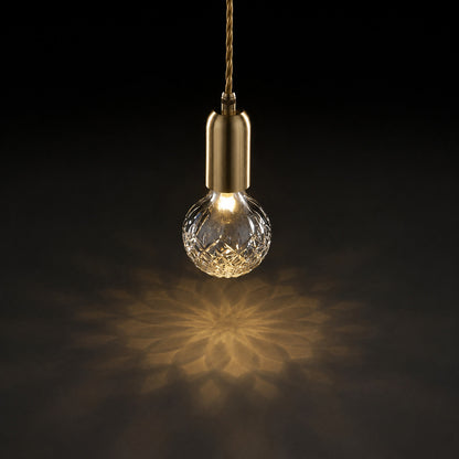 Warm light sparkling through the faceted cut-glass shade of the Diamante pendant like fine crystal
