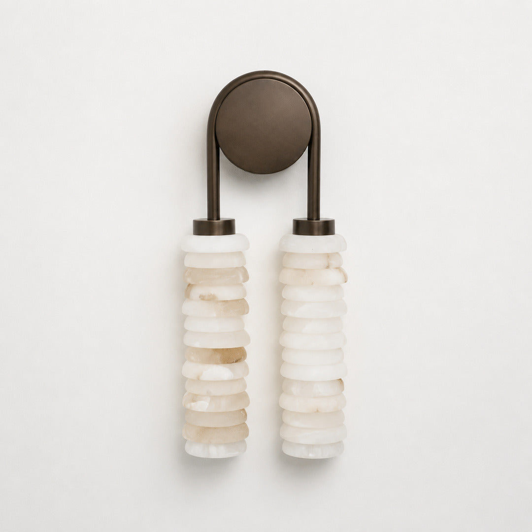 Detail of the stacked alabaster rings forming the ribbed texture on the Duetto wall sconce