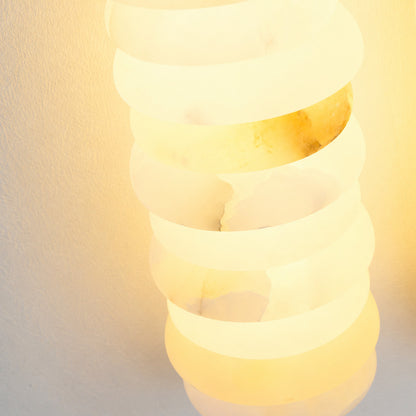 Warm integrated LED glow diffusing through the ribbed alabaster columns of the Duetto wall sconce