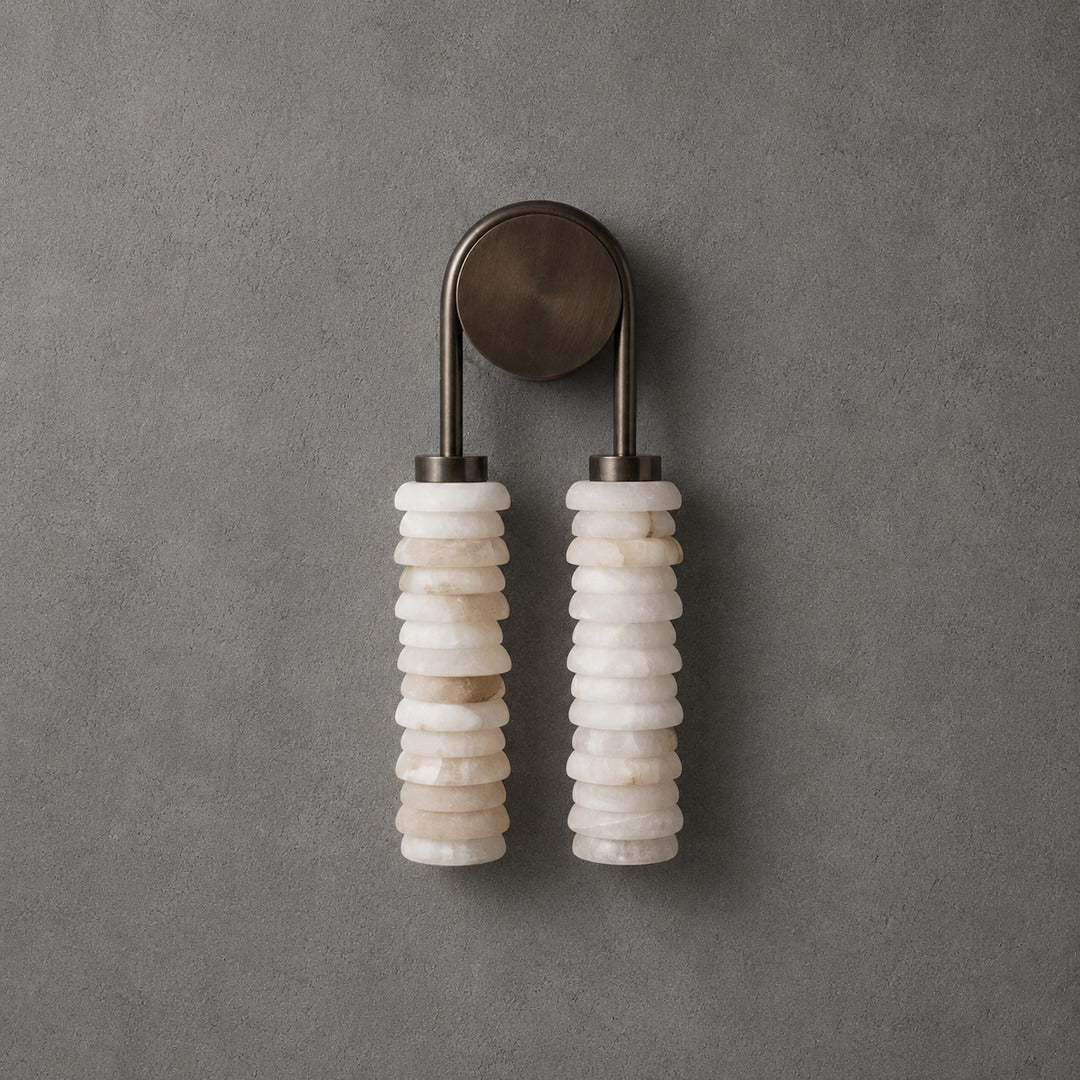 Bronze-finish Duetto alabaster wall sconce as a refined accent on a living room wall