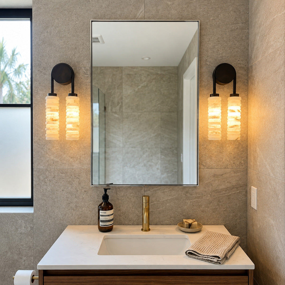 Duetto alabaster wall sconces flanking a vanity mirror in a dry powder room