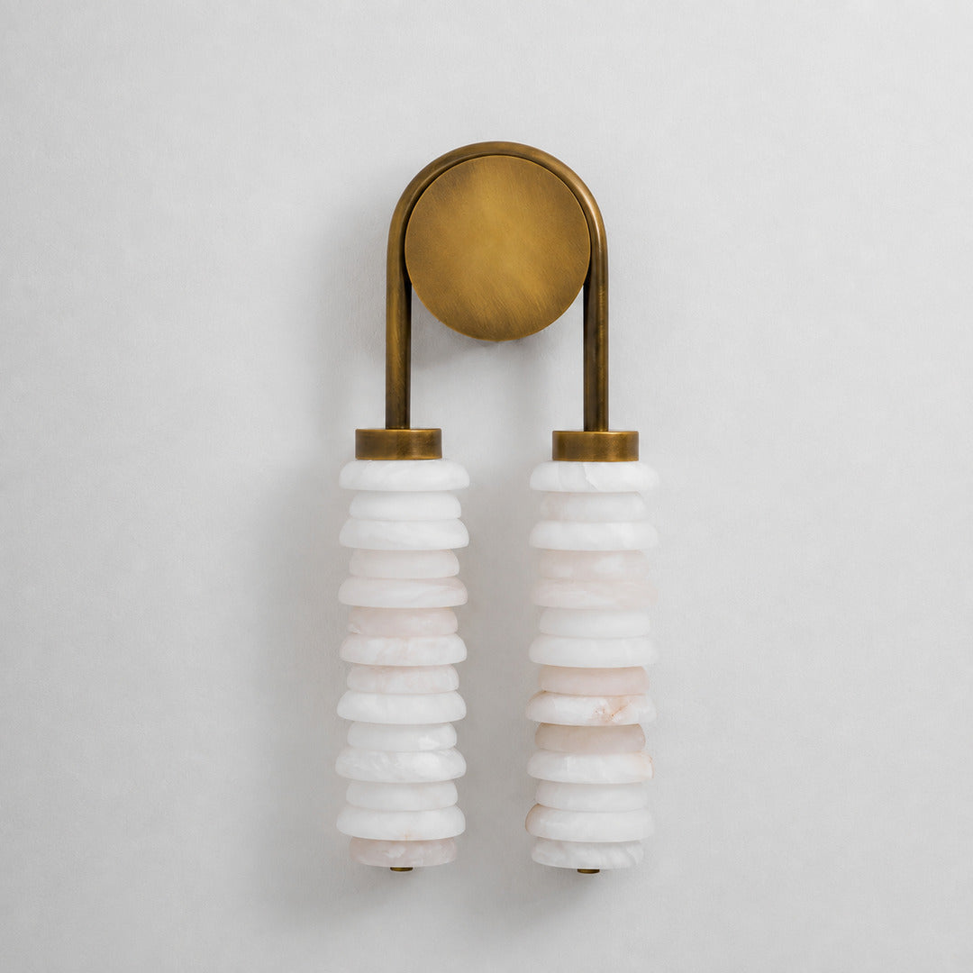 Antique brass Duetto alabaster wall sconce as a warm sculptural accent on a hallway wall