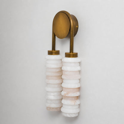 Detail of the stacked alabaster rings forming the ribbed texture on the Duetto wall sconce