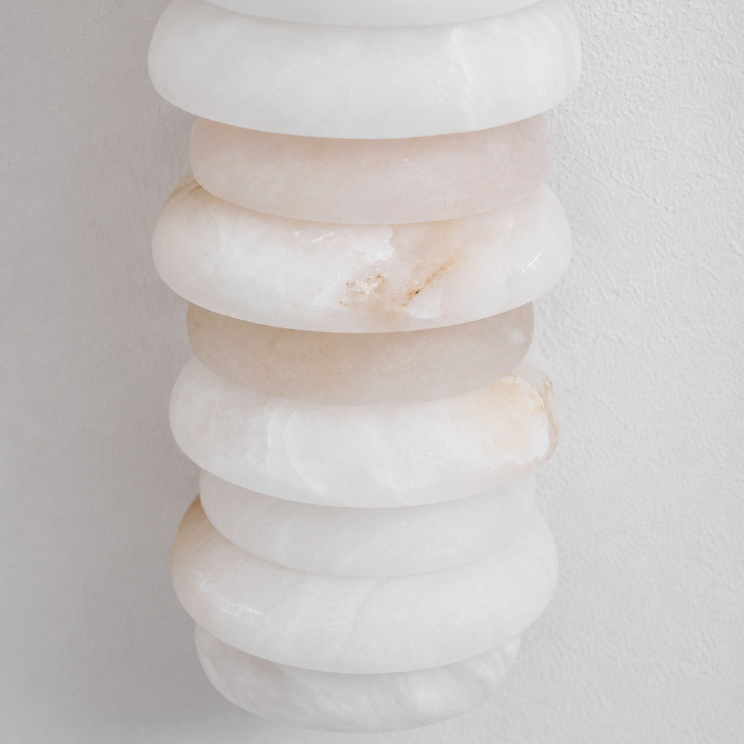 Natural veining and translucency of the alabaster rings on the Duetto wall sconce, unique to each piece