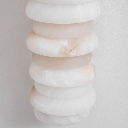 Natural veining and translucency of the alabaster rings on the Duetto wall sconce, unique to each piece