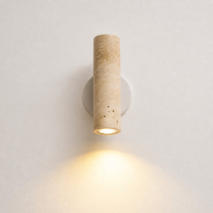 Duplo travertine wall sconce illuminated up and down warm glow travertine stone wall light beam white background