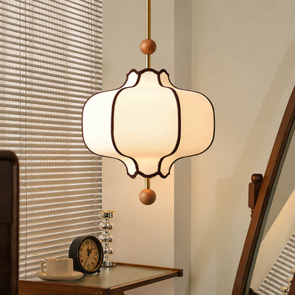 Dynasty lantern pendant light casting a warm glow over a corner reading chair