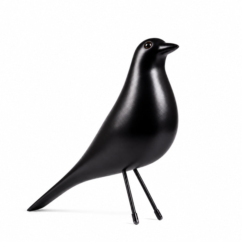 Eames House Bird mid-century wooden bird sculpture displayed as a decorative accent on a modern shelf