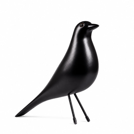 Eames House Bird mid-century wooden bird sculpture displayed as a decorative accent on a modern shelf