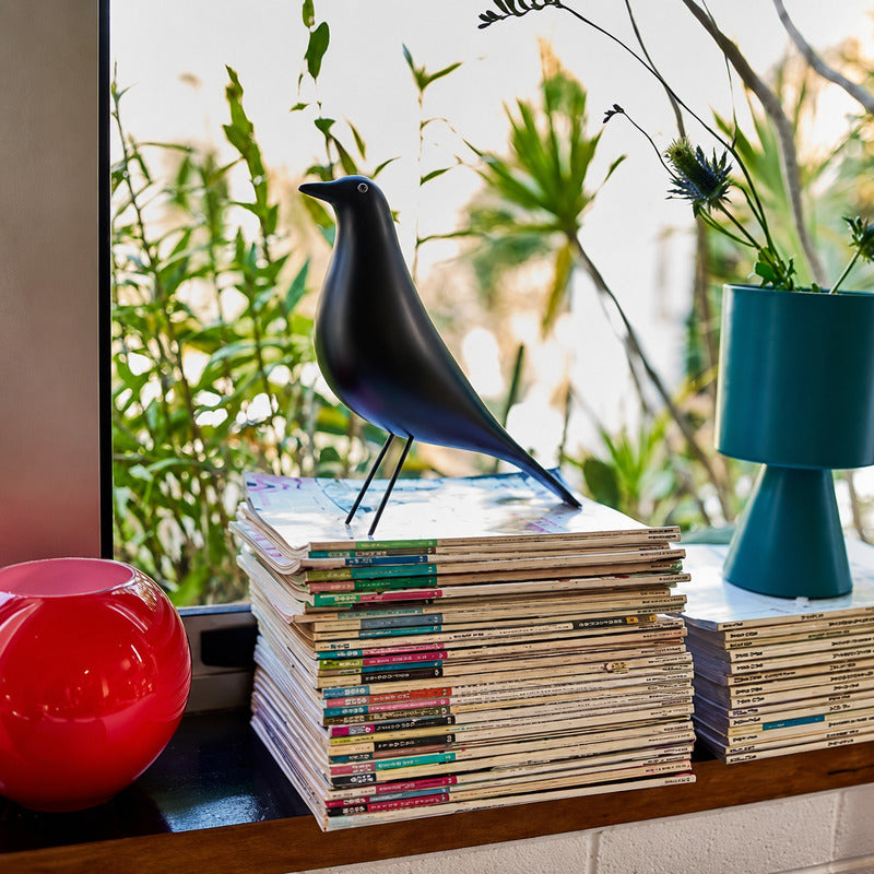 Eames House Bird sculpture styled as a decorative accent on a modern living room bookshelf