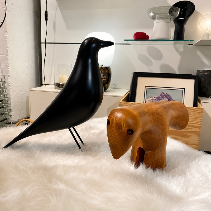 Eames House Bird sculpture styled as a decorative accent on a modern living room bookshelf