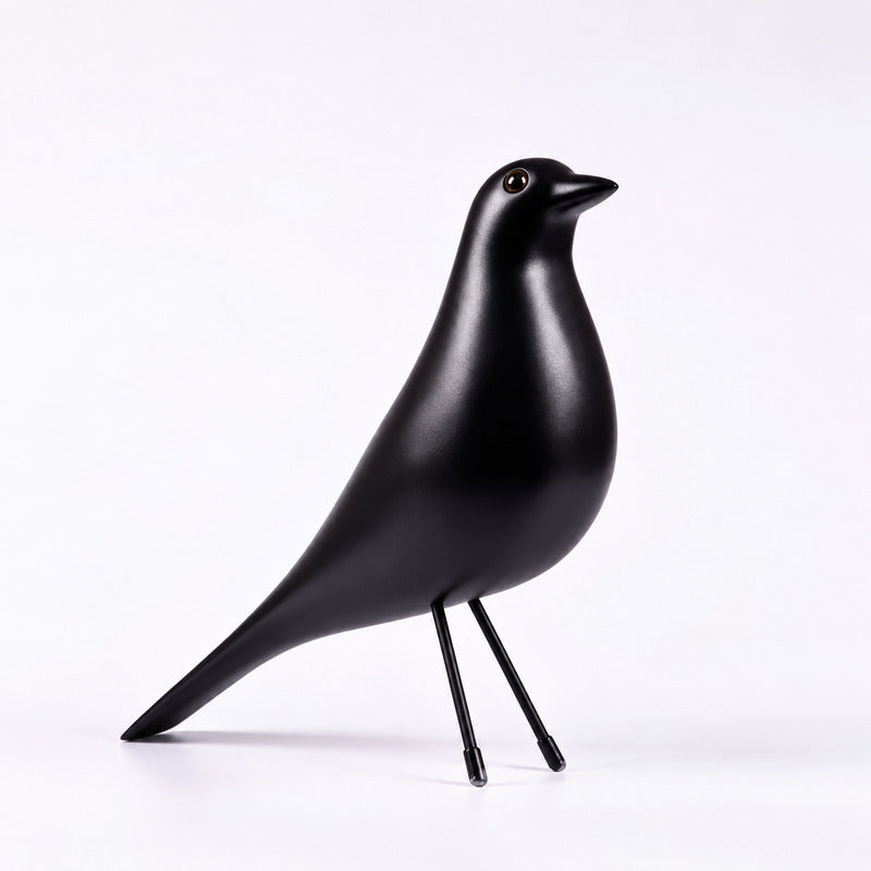 Black Eames House Bird sculpture as a bold mid-century accent on a bookshelf