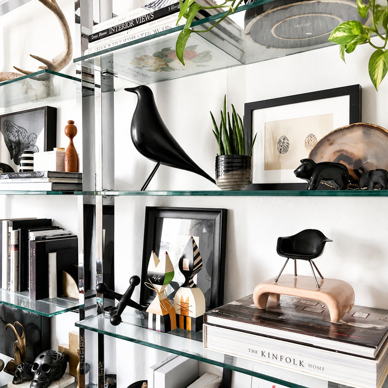 Eames House Bird sculpture styled as a decorative accent on a modern living room bookshelf