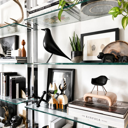 Eames House Bird sculpture styled as a decorative accent on a modern living room bookshelf