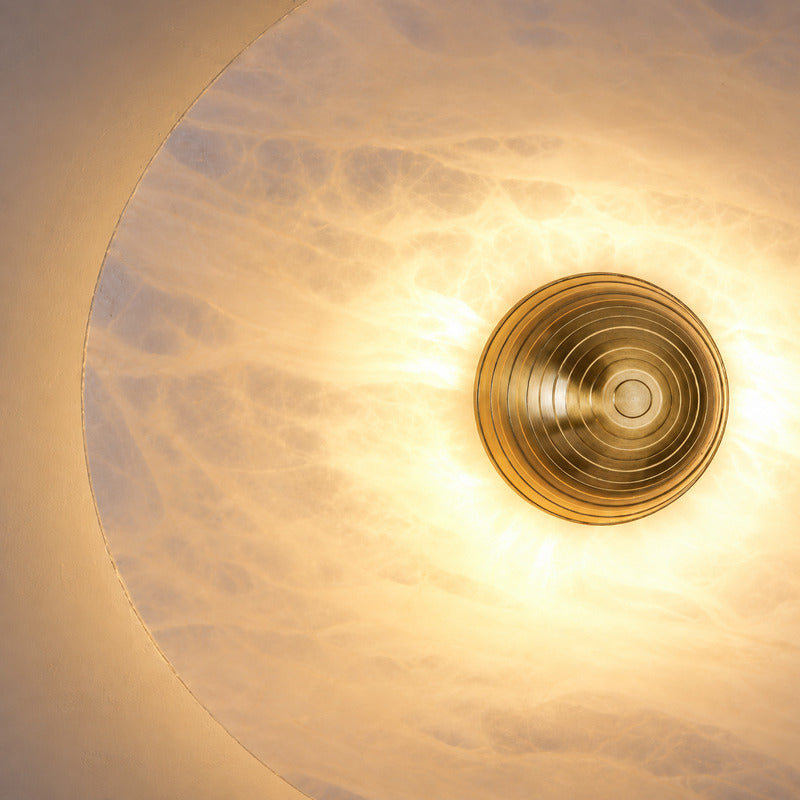 Natural veining and translucency of the alabaster disc on the Eclisse wall sconce, unique to each piece