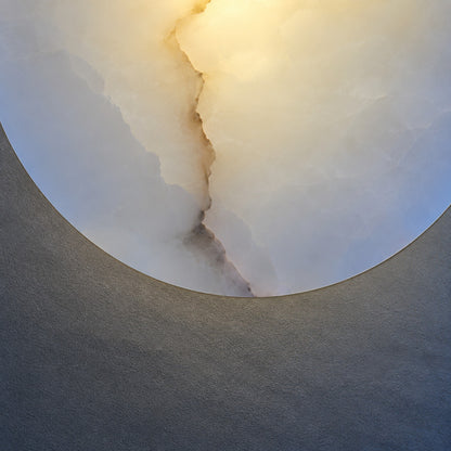 Natural veining and translucency of the alabaster disc on the Eclisse wall sconce, unique to each piece