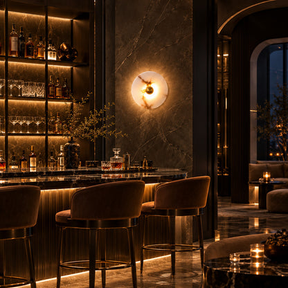Eclisse alabaster wall sconces adding warm round accents along an upscale restaurant wall