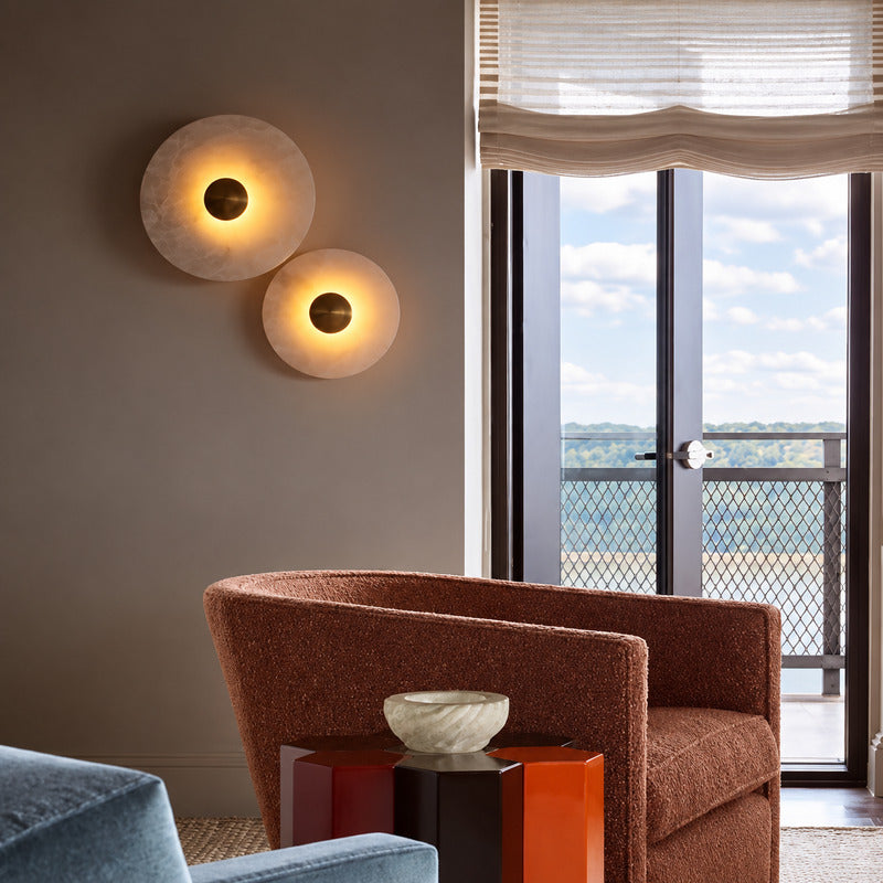 Eclisse alabaster wall sconce as a warm sculptural accent on a modern living room wall