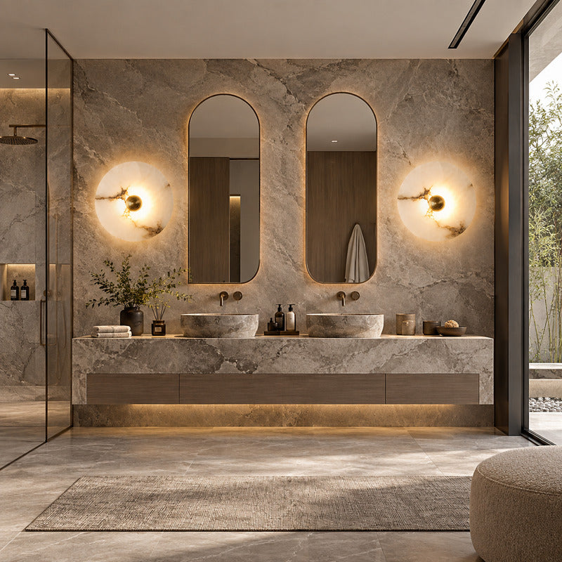 Eclisse alabaster wall sconce beside a vanity mirror in a dry dressing area