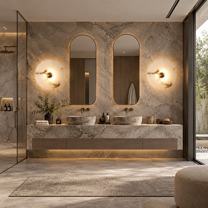 Eclisse alabaster wall sconce beside a vanity mirror in a dry dressing area