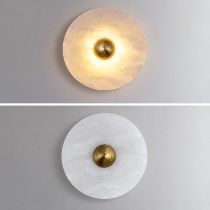 Hidden warm LED glow diffusing softly through the alabaster disc of the Eclisse wall sconce
