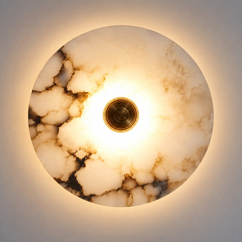 Hidden warm LED glow diffusing softly through the alabaster disc of the Eclisse wall sconce