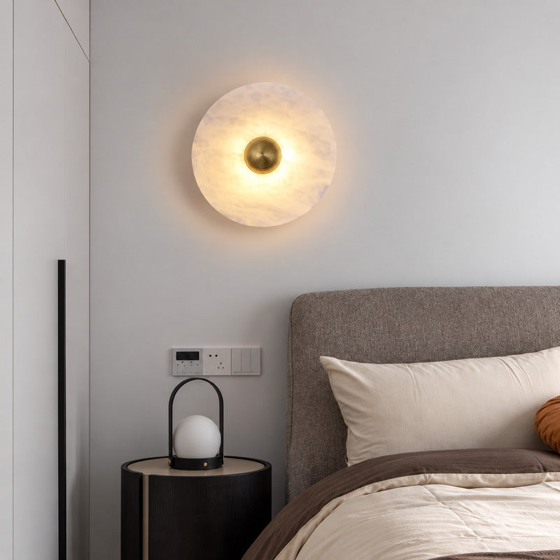 Pair of Eclisse alabaster wall sconces flanking a bed for warm symmetrical bedside lighting