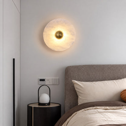 Pair of Eclisse alabaster wall sconces flanking a bed for warm symmetrical bedside lighting
