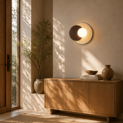 Eclisse travertine wall sconce entryway foyer warm glow glass globe travertine stone wood American home lifestyle interior styled