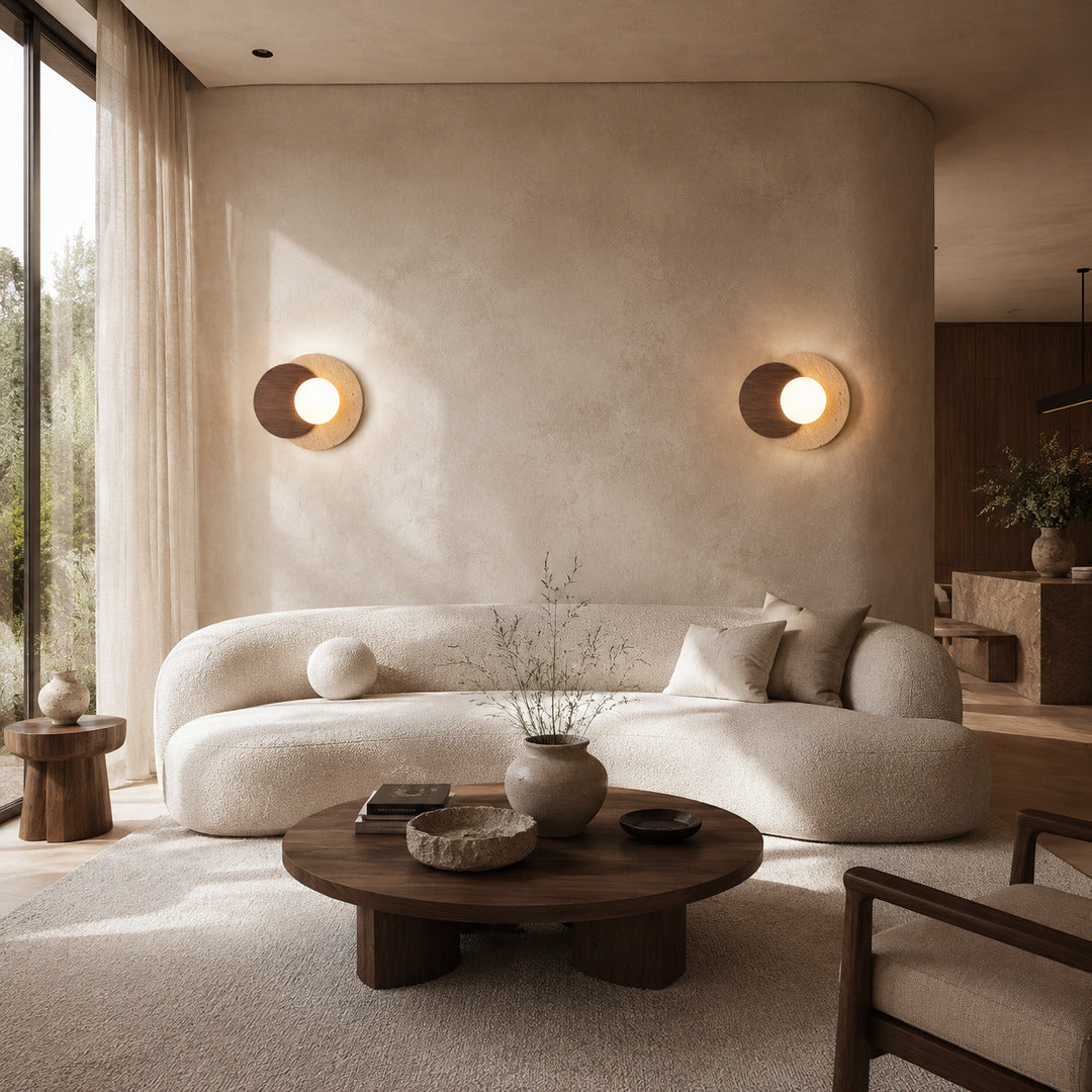 Eclisse travertine wall sconce living room wall warm glow glass globe travertine stone wood sculptural American home lifestyle interior styled