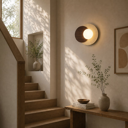 Eclisse travertine wall sconce staircase stairwell warm glow glass globe travertine stone wood American home lifestyle interior styled