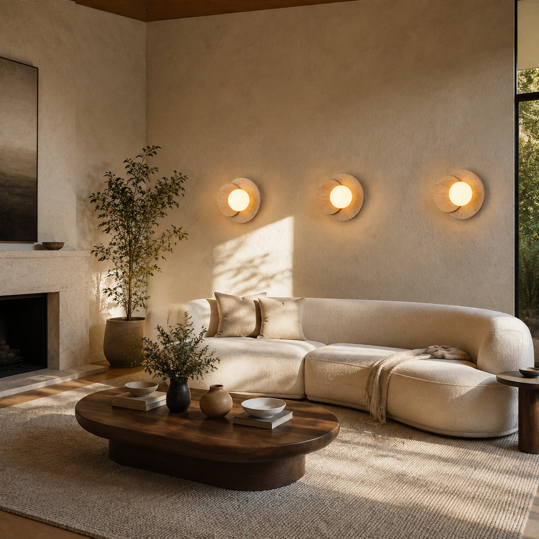 Eclisse travertine wall sconce living room wall warm glow glass globe travertine stone wood sculptural American home lifestyle interior styled