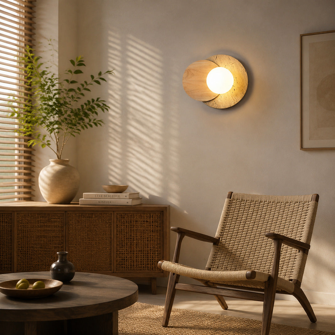 Eclisse travertine wall sconce living room wall warm glow glass globe travertine stone wood sculptural American home lifestyle interior styled
