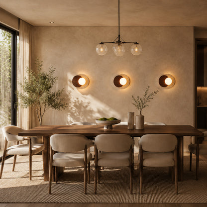 Eclisse travertine wall sconce living room wall warm glow glass globe travertine stone wood sculptural American home lifestyle interior styled